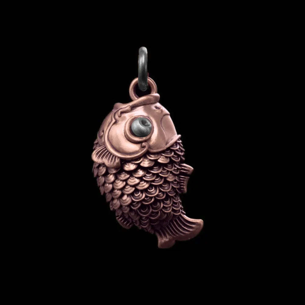 Copper and oxidized silver Koi Fidget Pendant on a black background