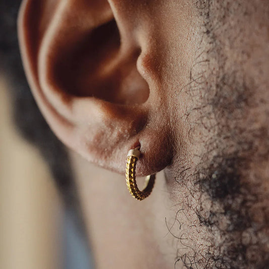 Model with brass snake scale earrings#Brass