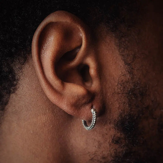 model with silver snake scale earrings