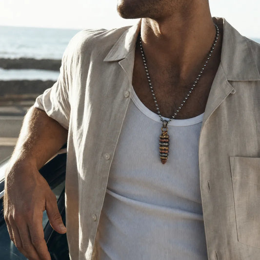 Tricolor rattlesnake tail pendant worn as a necklace by a woman