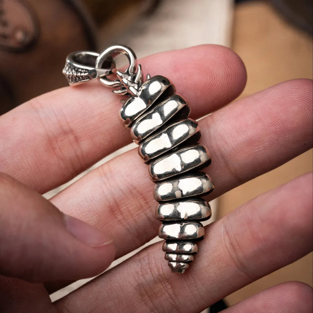 Polished White Bronze Rattlesnake Tail Pendant handheld closeup