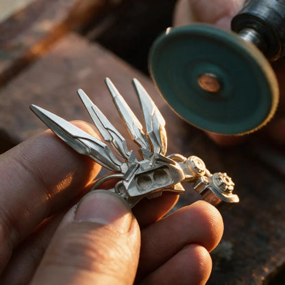 Hand-polishing the sculpted metal wing of a Mech Justicar magnetic figurine