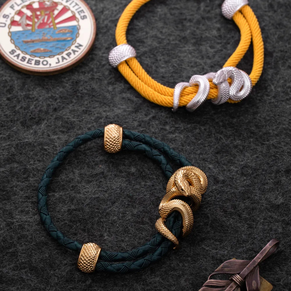 Black Mamba Rope Bracelet in 24K Gold Plated Brass, held in hand with the complete rope bracelet visible.