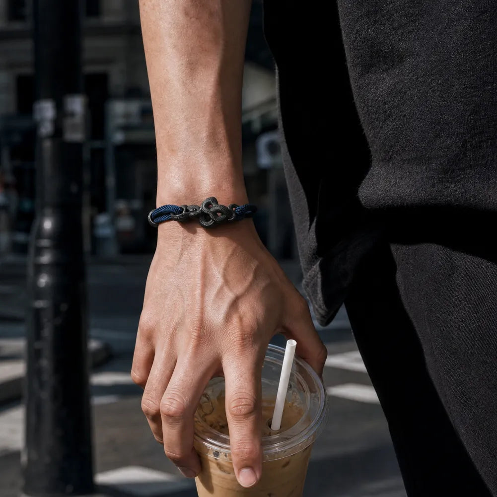 Blackened Black Mamba rope bracelet worn on a mans wrist