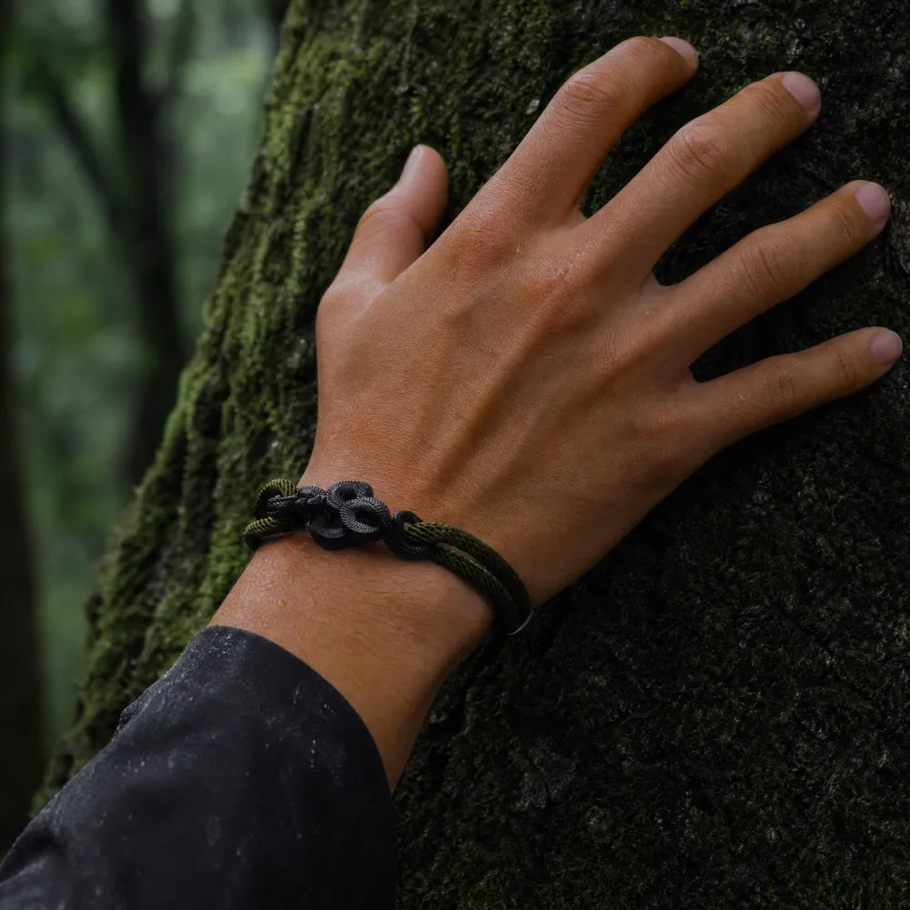 Blackened Black Mamba rope bracelet worn outdoors on the wrist