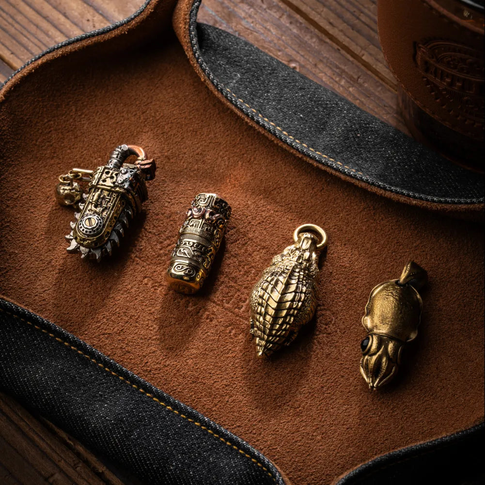 Crocodile pendant shown with three other sculpted metal charms.