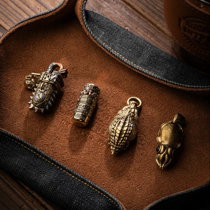 Crocodile pendant shown with three other sculpted metal charms.