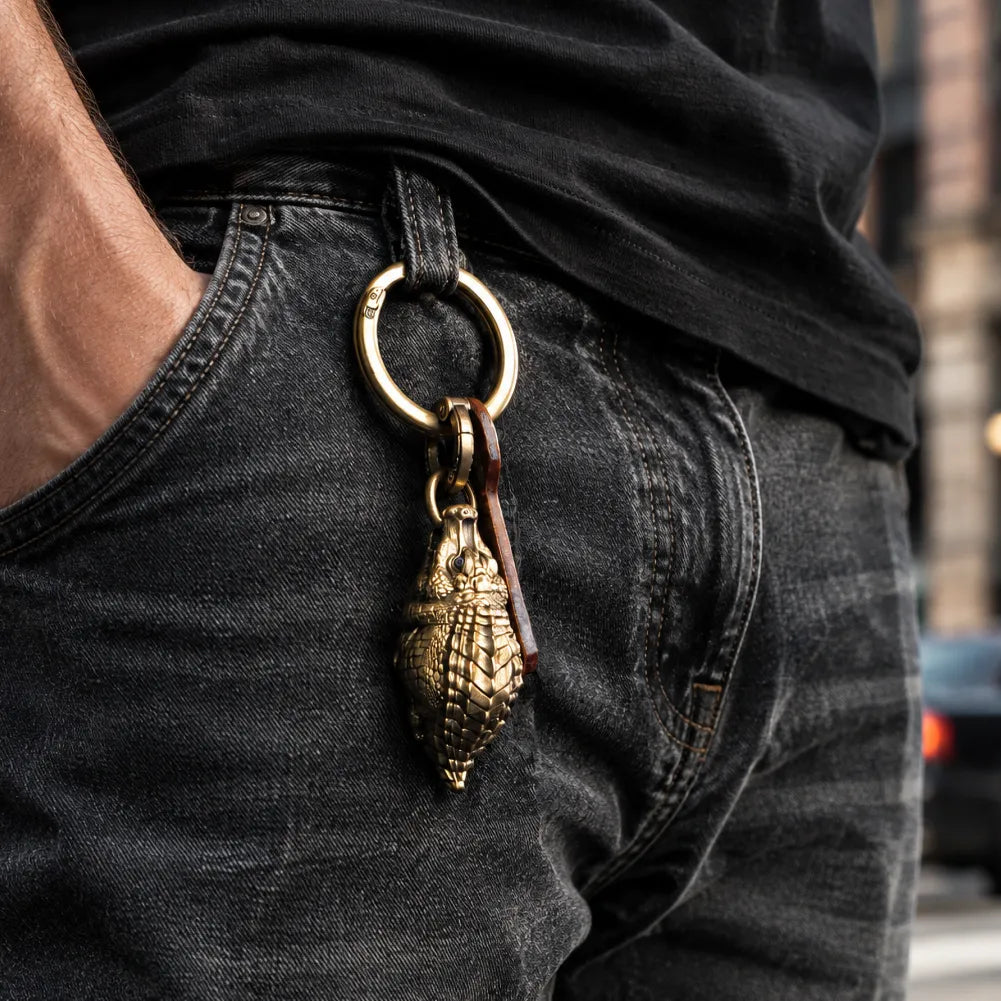 Crocodile pendant keychain attached to a jeans pocket.