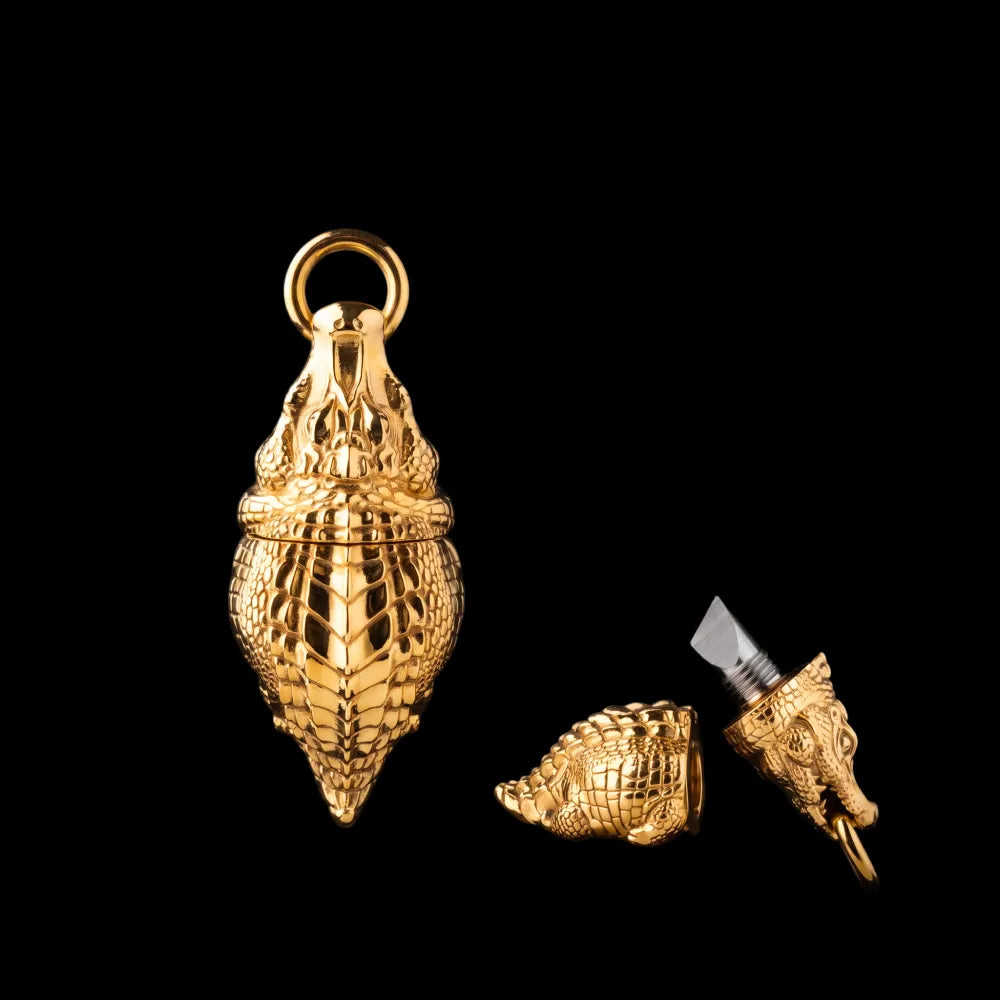 Crocodile box opener pendant in gold tone.