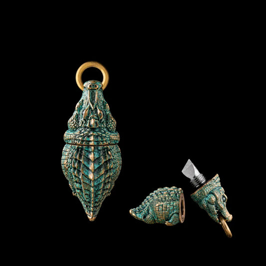 Crocodile box opener pendant in green patina with gold-tone connector rings.