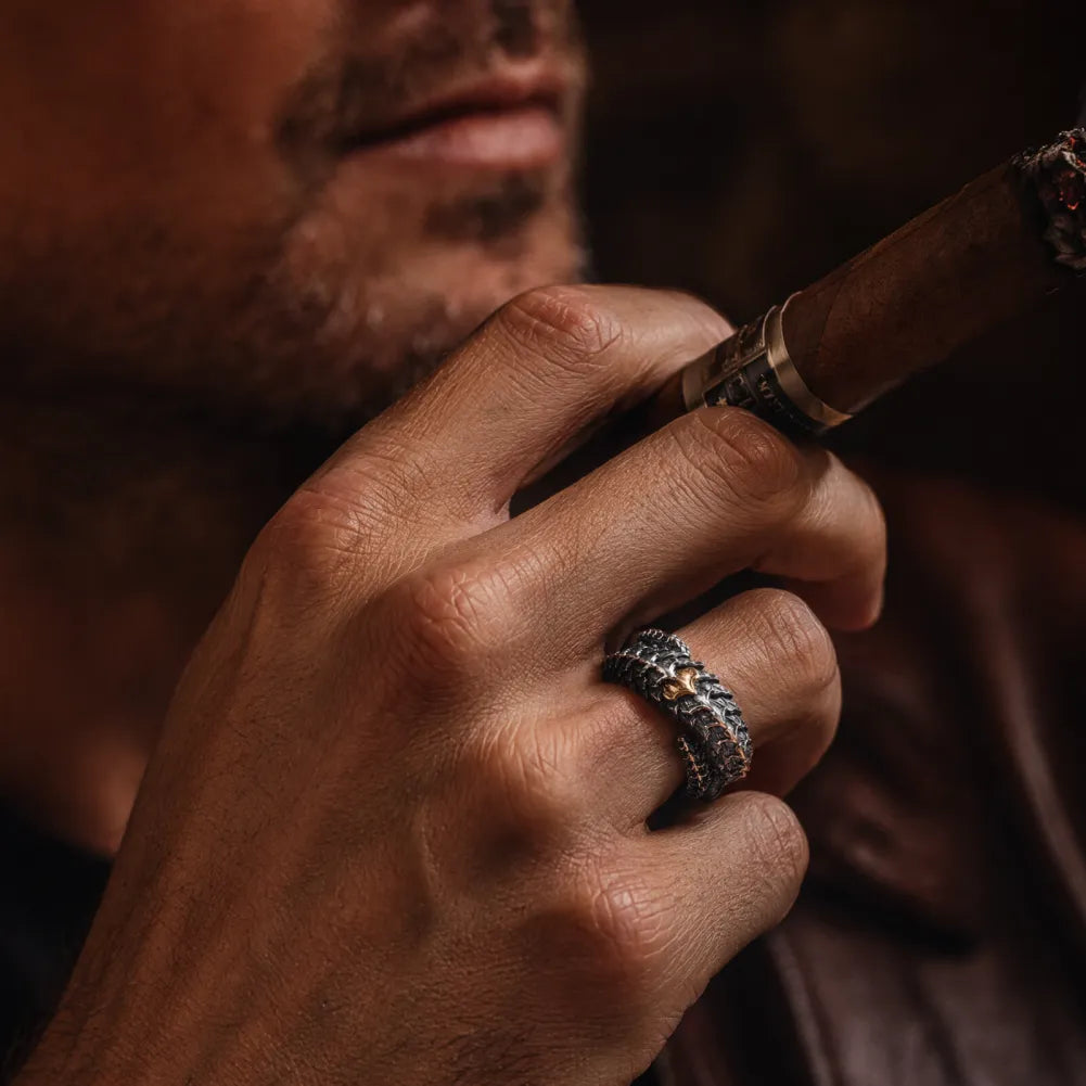 Man wearing the handcrafted Dragon Scale Ring 2.0 in a close-up lifestyle setting