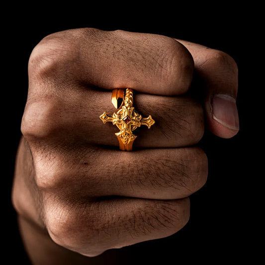 Gold-tone Judicator Blade ring worn on a closed hand.