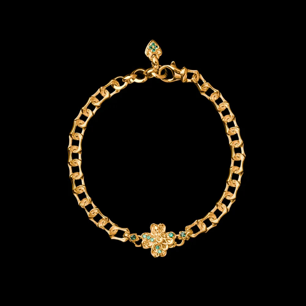 Gold-tone Lucky Clover Snake Bracelet with green clover details on a black background