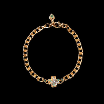 Gold-tone Lucky Clover Snake Bracelet on a black background