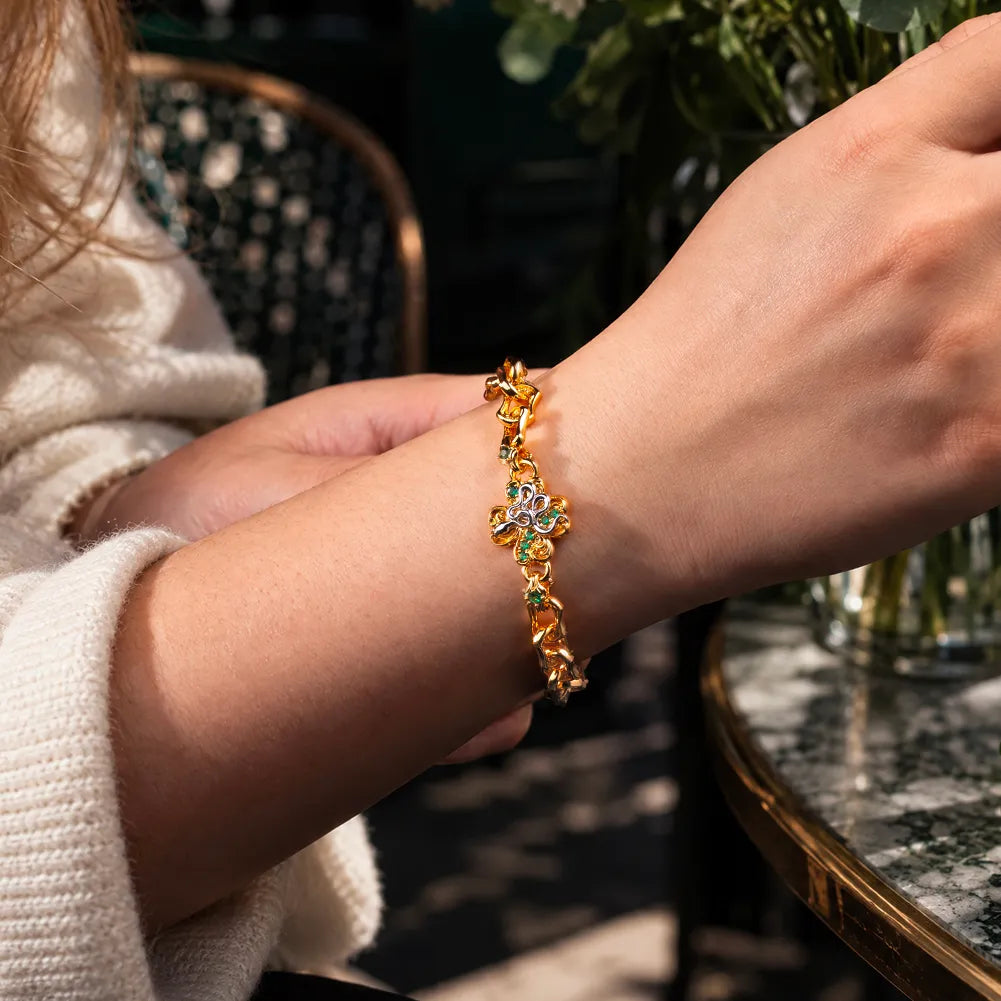 Gold-tone Lucky Clover Snake Bracelet worn on the wrist