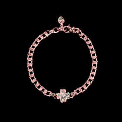 Rose-gold-tone and light-tone Lucky Clover Snake Bracelet with green clover details on a black background