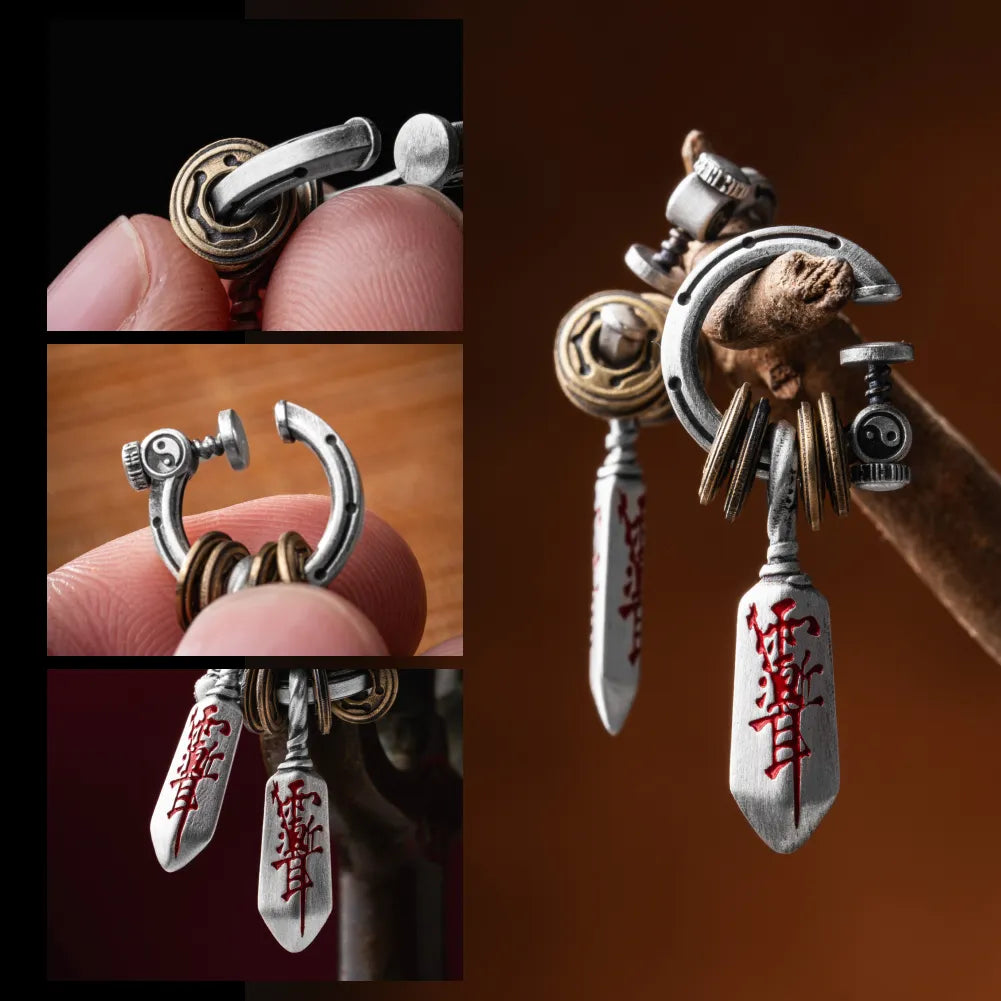 Masterblade talisman clip-on earring held in hand
