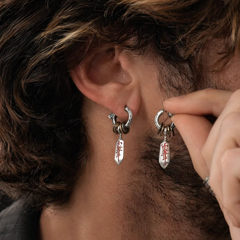 Pair of Masterblade talisman clip-on earrings shown in detail