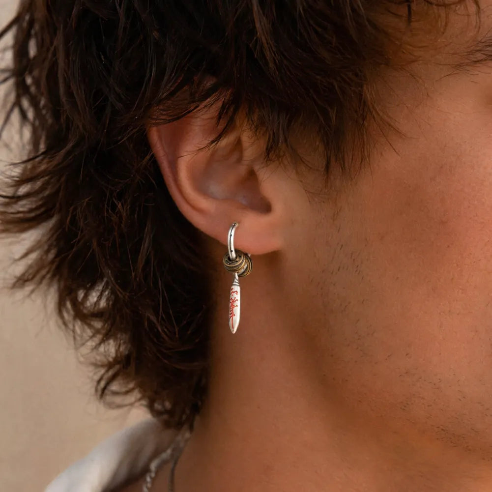 Man wearing a Masterblade talisman clip-on earring