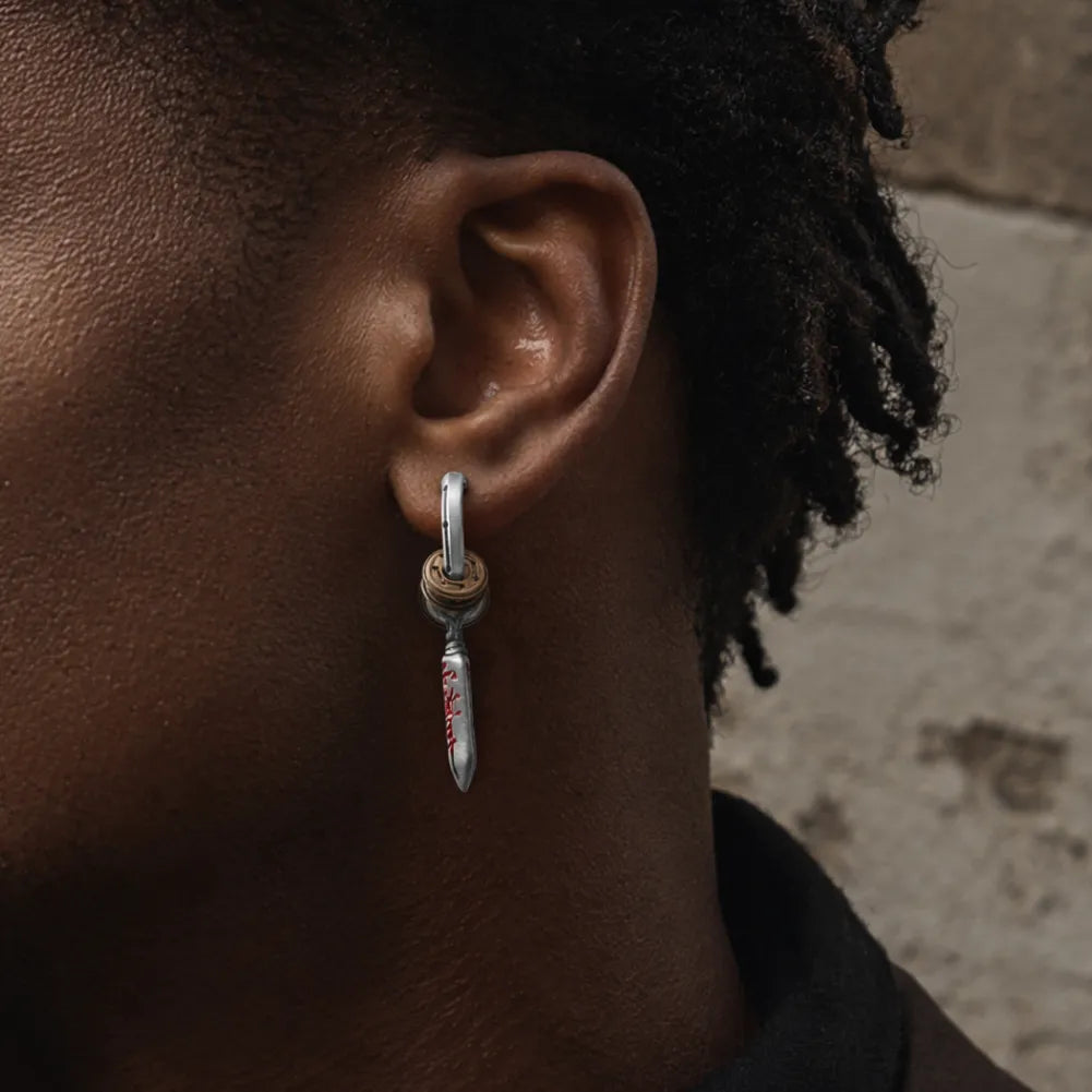 Woman wearing Masterblade talisman clip-on earrings in a close-up view