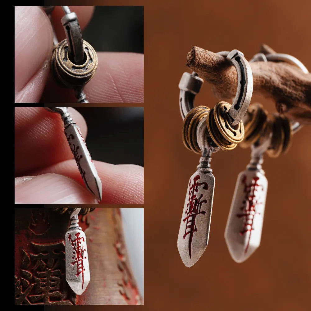 Blade charm and hoop details of Masterblade talisman earrings
