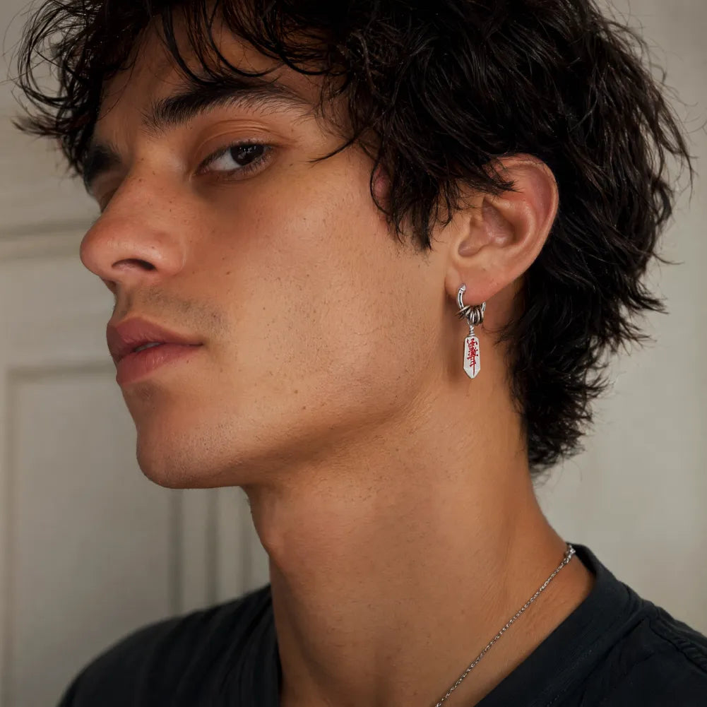 Man wearing a Masterblade talisman earring in a front view
