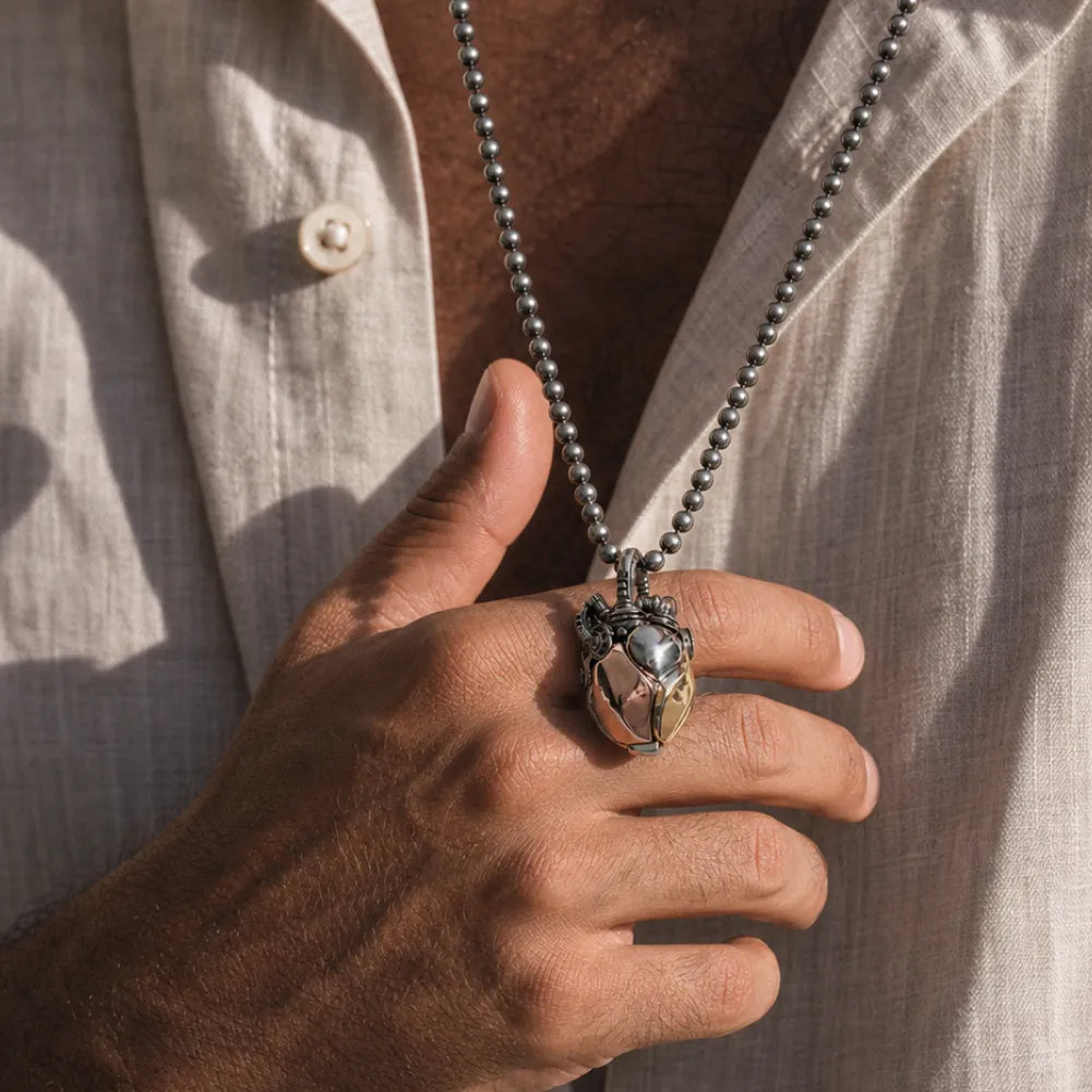 White Bronze & Brass & Copper Mechanical Heart Pendant worn in a men's lifestyle scene