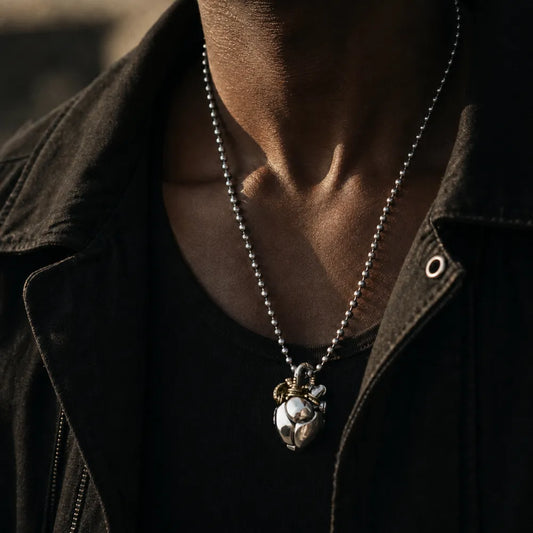 White Bronze & Brass Mechanical Heart Pendant worn as a statement necklace in a lifestyle portrait