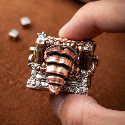 Mimicling Chest Pendant held in hand showing its articulated details