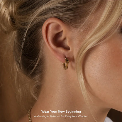 Woman wearing Ouroboros hoop earrings in a close-up view
