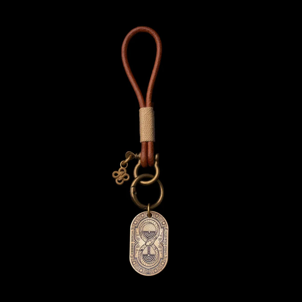 Ouroboros Hourglass Tag shown with a leather loop and ring