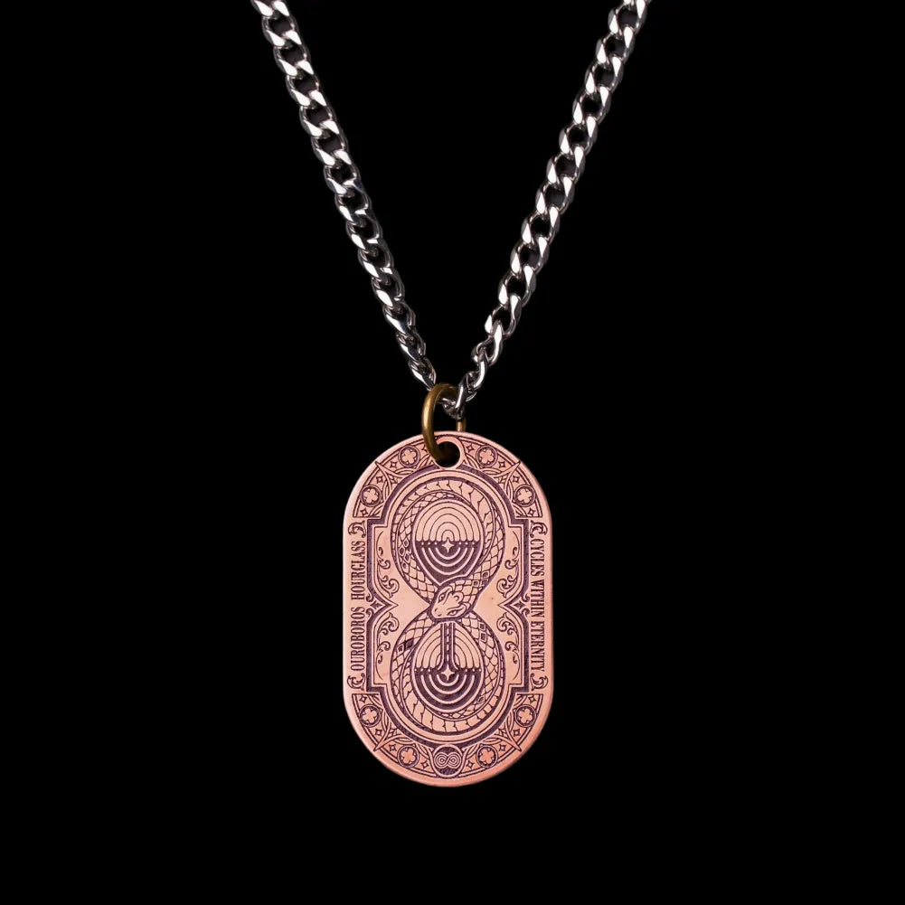 Ouroboros Hourglass Tag SKU image 1 in gold-tone finish; attachment examples are not included