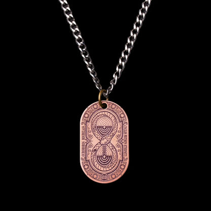 Ouroboros Hourglass Tag SKU image 1 in gold-tone finish; attachment examples are not included