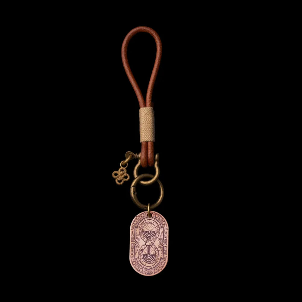 Ouroboros Hourglass Tag SKU image 3 in gold-tone finish; attachment examples are not included