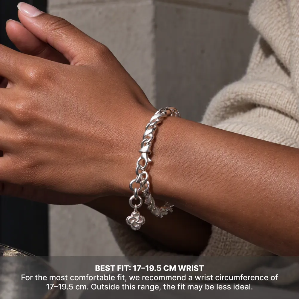 Silver Ouroboros Infinity Bracelet worn with a cream sweater, with a recommended wrist circumference of 17 to 19.5 cm