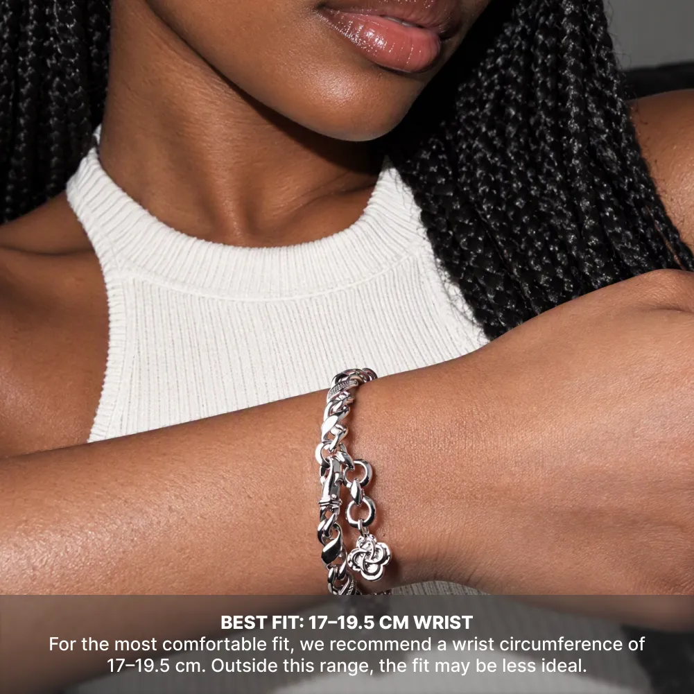 Silver-tone Ouroboros Infinity Bracelet worn with a white top, with a recommended wrist circumference of 17 to 19.5 cm