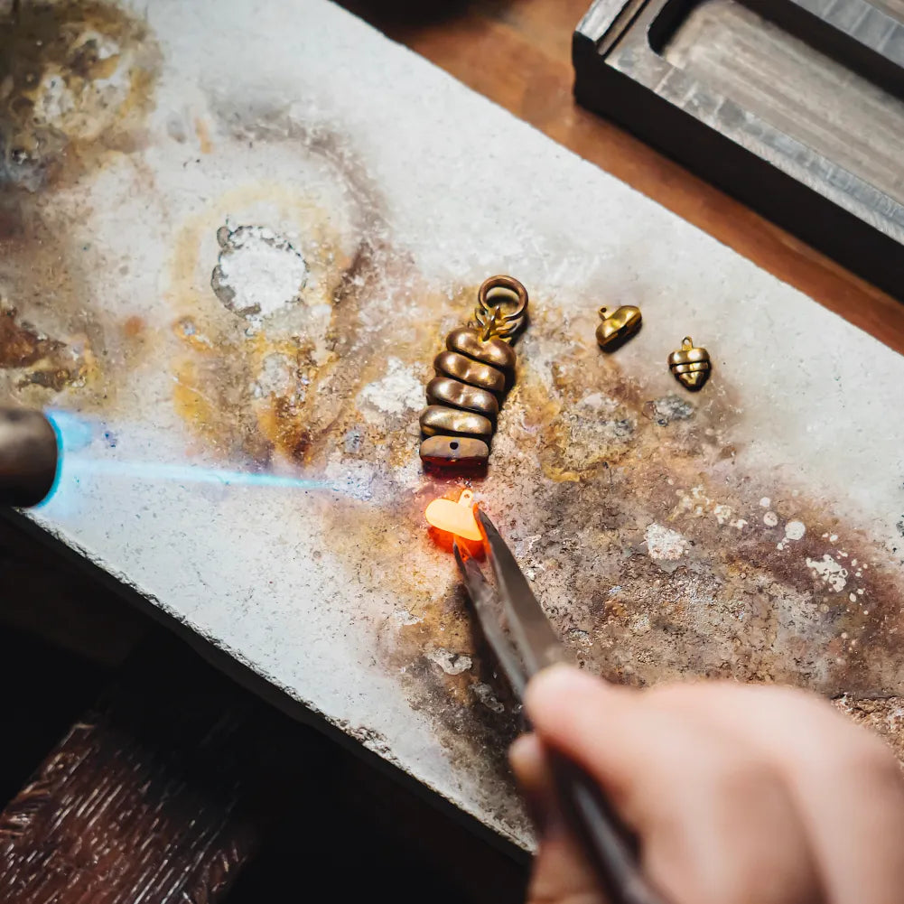 Artisan working on a Rattlesnake Tail earring by hand