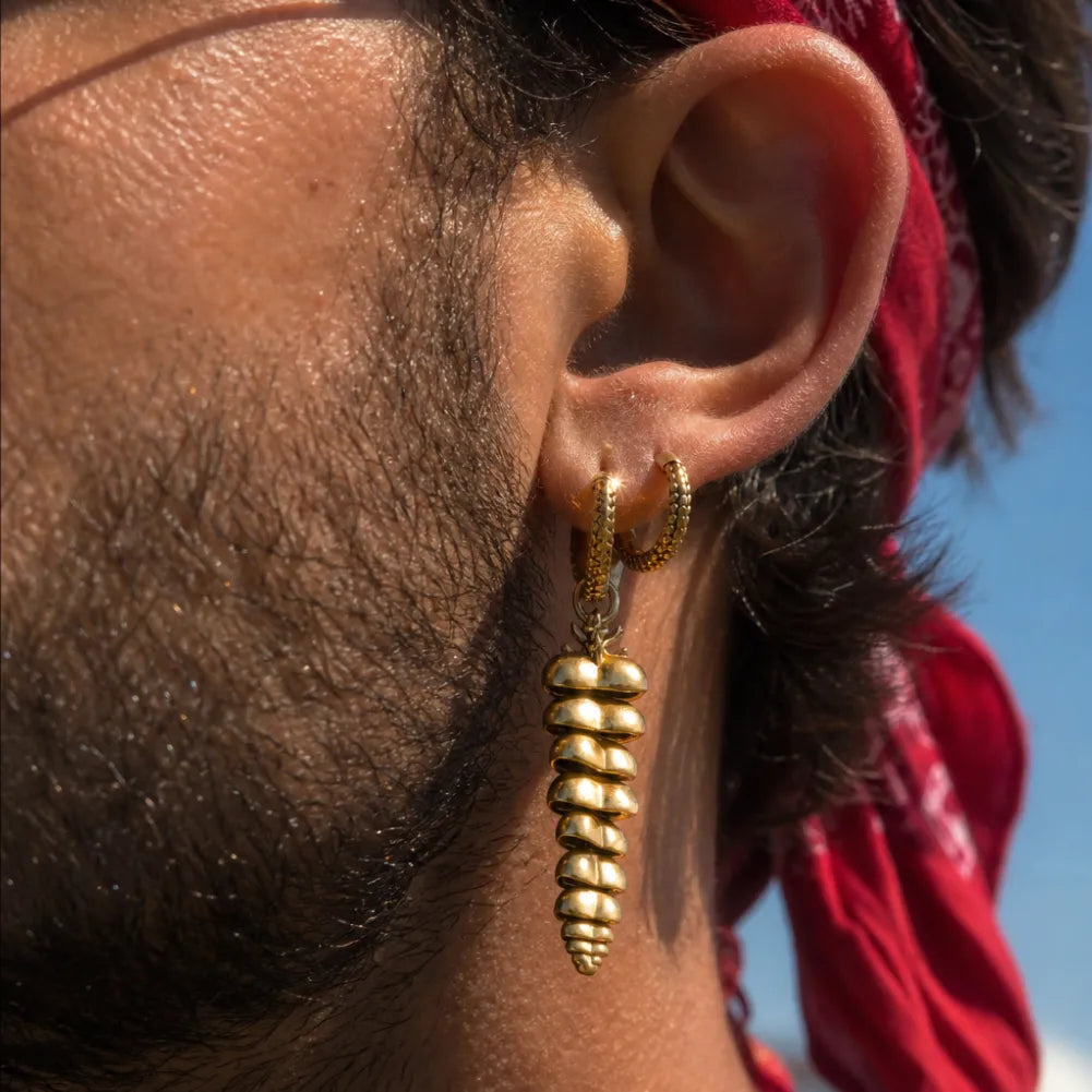 Close-up of a man wearing Rattlesnake Tail earrings