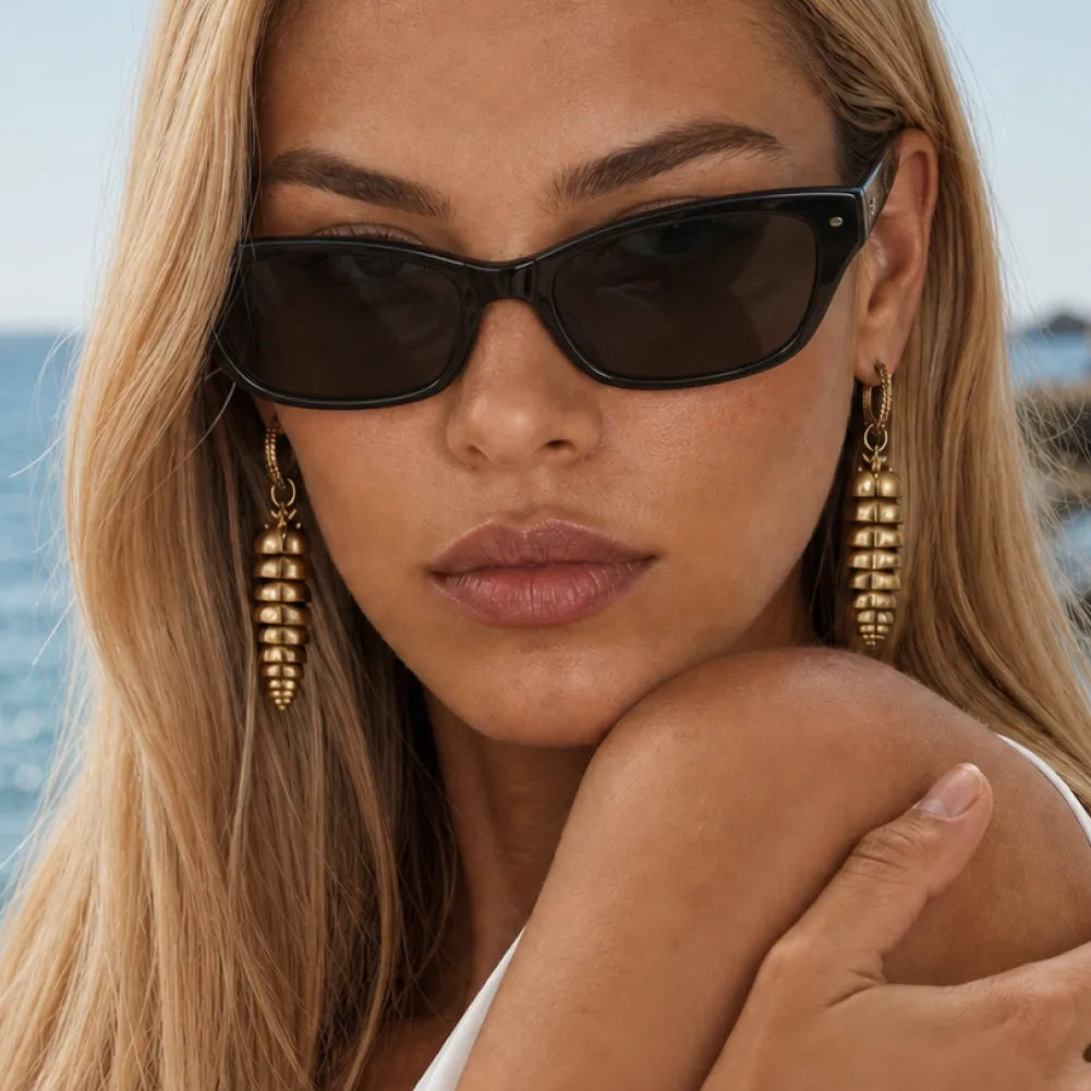Woman wearing long Rattlesnake Tail earrings with sunglasses