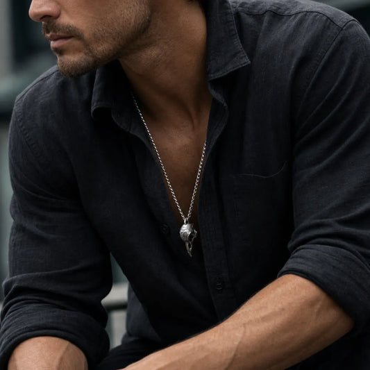 Man wearing the White Bronze Raven Skull Pendant
