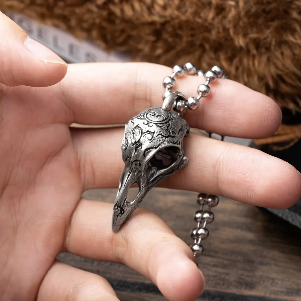 White Bronze Raven Skull Pendant held in hand