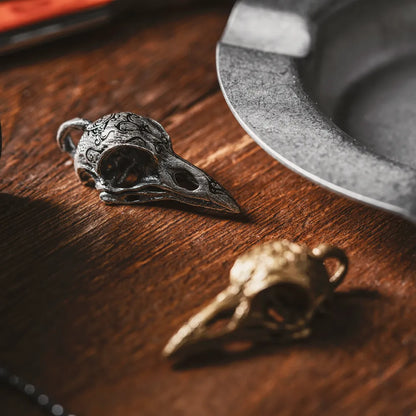 Raven Skull Pendant displayed on a wooden surface