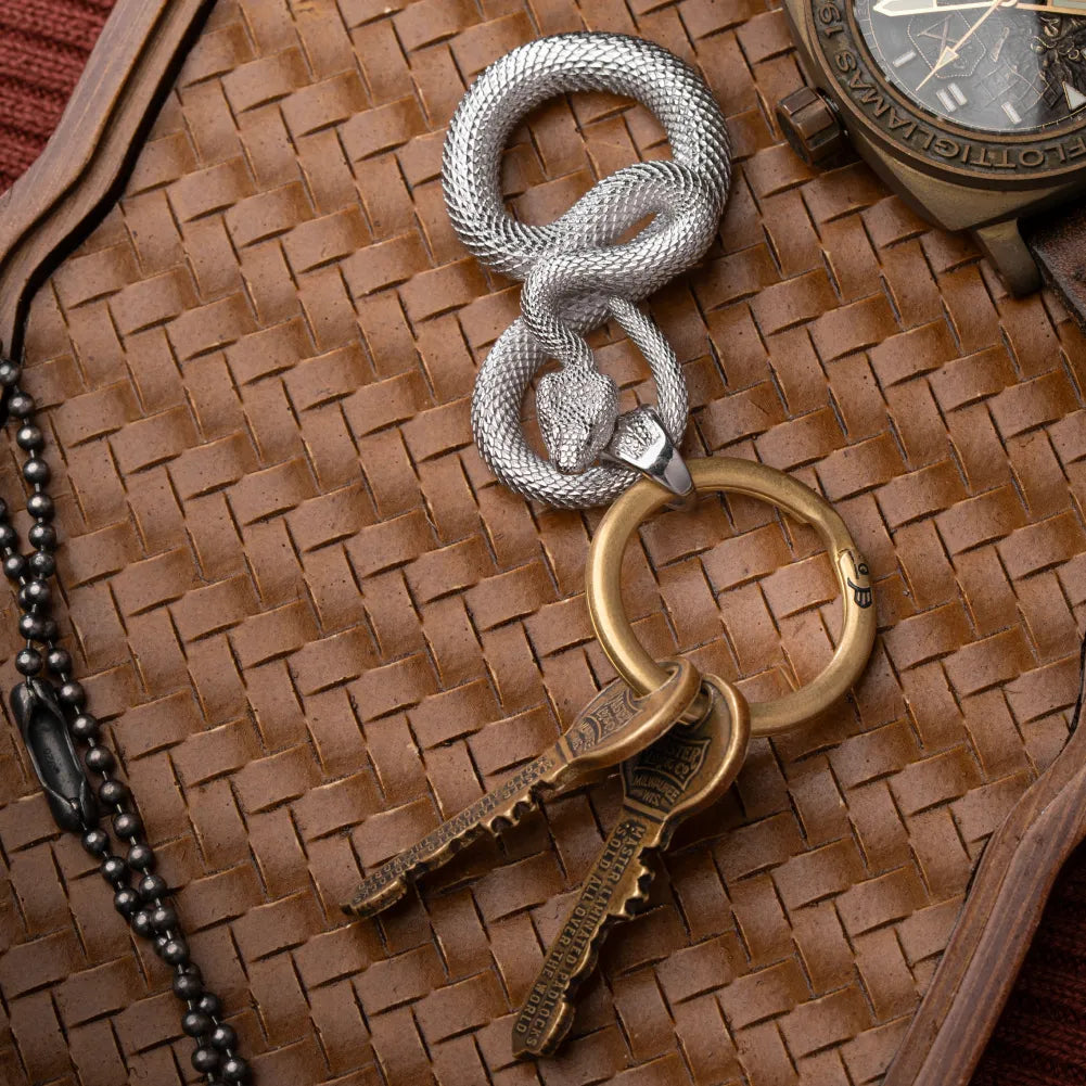 Snake Keychain in 18K White Gold Plated White Bronze, held in hand with keys in an everyday-carry lifestyle view.