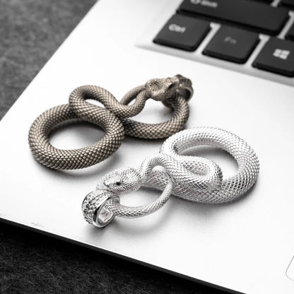 Snake Keychain in 18K White Gold Plated White Bronze, multiple finishes arranged in a flat-lay comparison.
