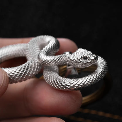 Snake Keychain in 18K White Gold Plated White Bronze, held close up with the snake head and loop construction visible.