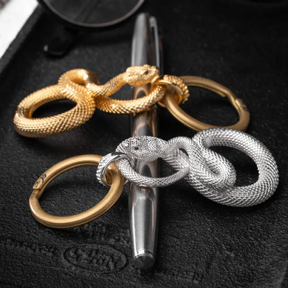 Snake Keychain in 18K White Gold Plated White Bronze, shown beside a wristwatch in a product close-up.