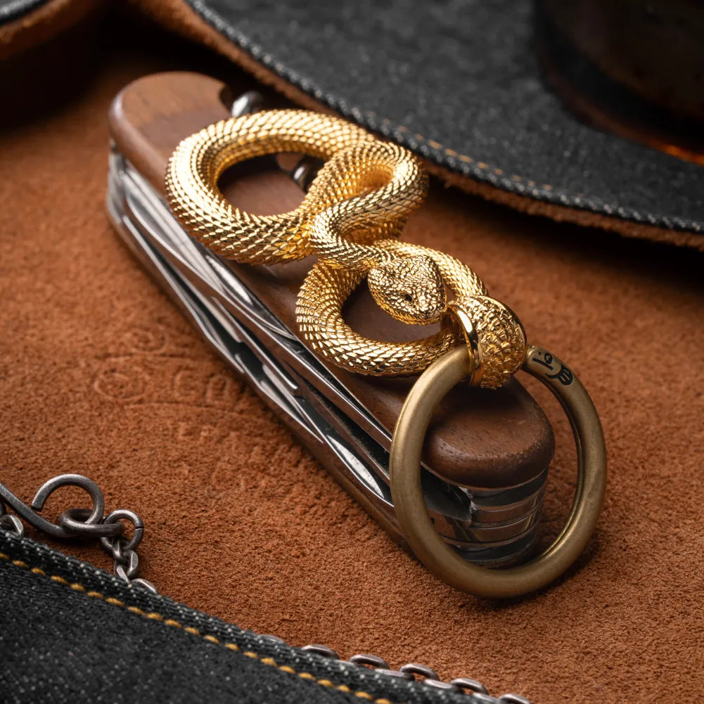 Snake Keychain in 24K Gold Plated Brass, held in hand with keys in an everyday-carry lifestyle view.