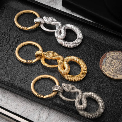 Snake Keychain in 24K Gold Plated Brass, multiple finishes arranged in a flat-lay comparison.