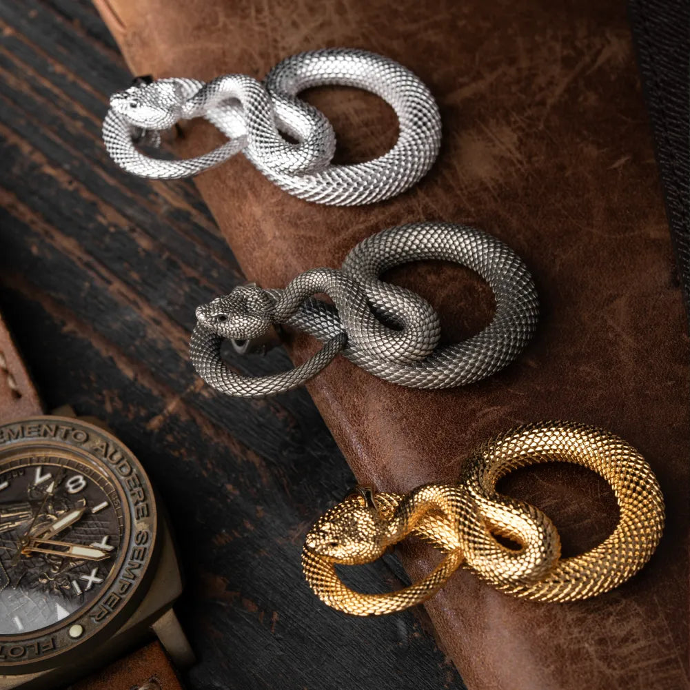 Snake Keychain in 24K Gold Plated Brass, shown beside a wristwatch in a product close-up.