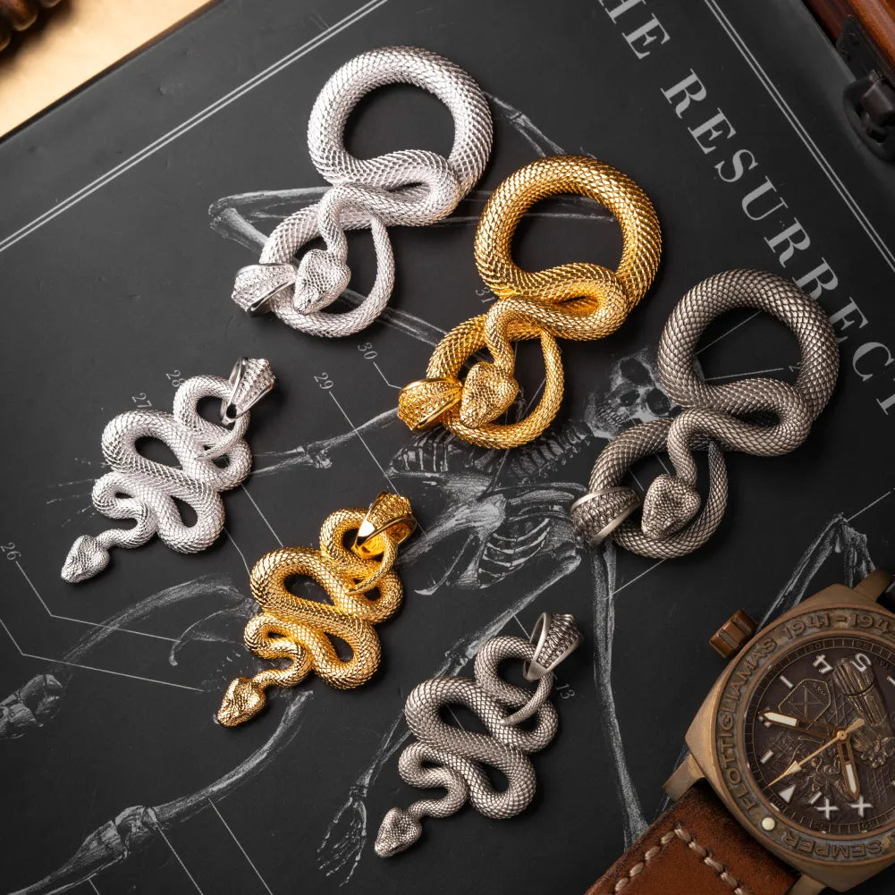 Snake Keychain in White Bronze, multiple finishes arranged in a flat-lay comparison.